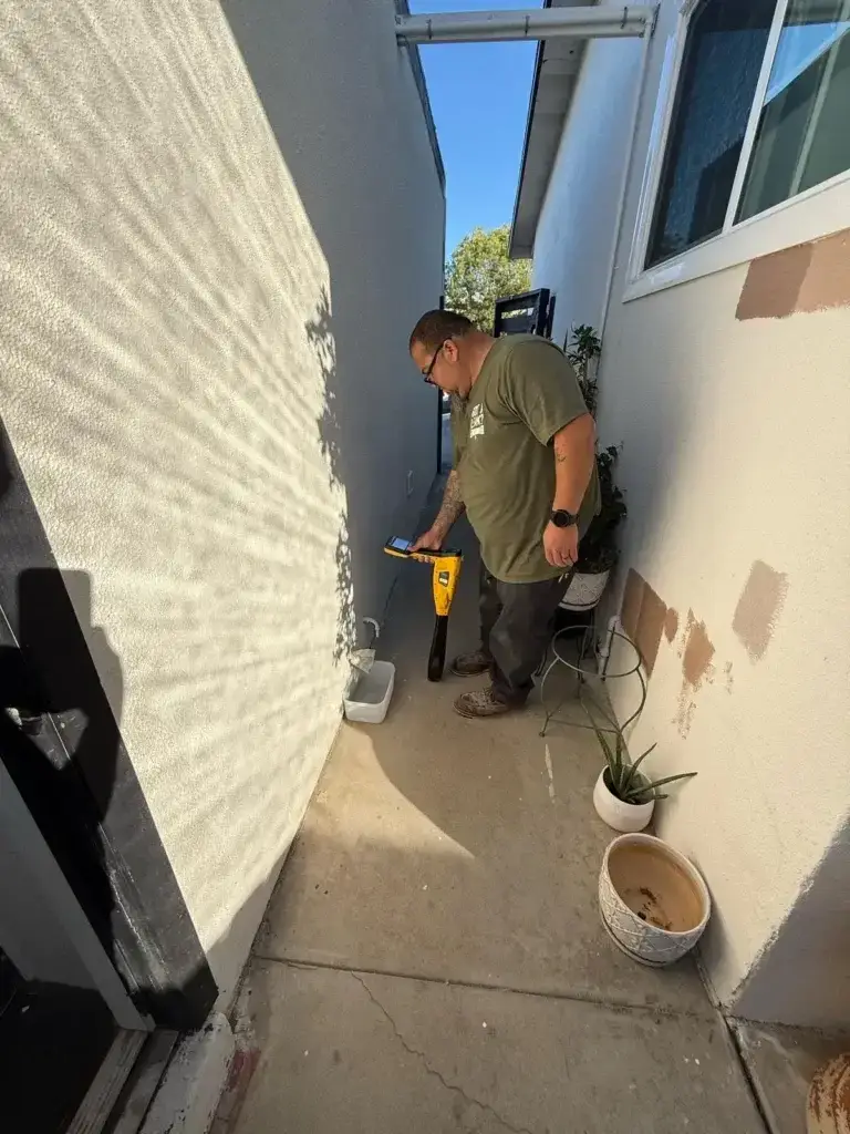 E-Drains technician performing professional leak detection in san diego outside a residential home.