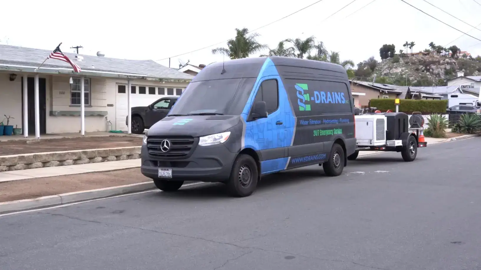 E-Drains service van parked outside a residential home, ready for 24/7 emergency plumbing in San Diego and drain services
